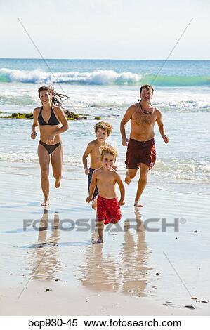 family running on beach in mexico View Large Photo Image Stock Photography - family running on beach in mexico. Fotosearch