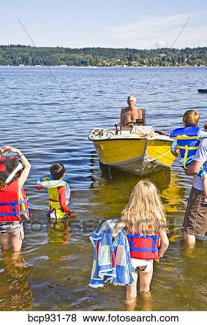 family wading out to motorboat View Large Photo Image Stock Photo - family wading out to motorboat. Fotosearch