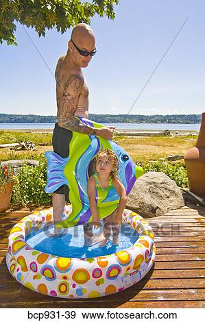 man and girl in wading pool near beach View Large Photo Image Stock Photo - man and girl in wading pool near beach. Fotosearch