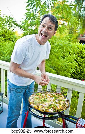 man cooking pizza on outdoor grill View Large Photo Image Stock Photography - man cooking pizza on outdoor grill. Fotosearch