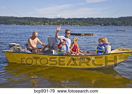 Stock Photo - men and young children on motorboat ride. Fotosearch