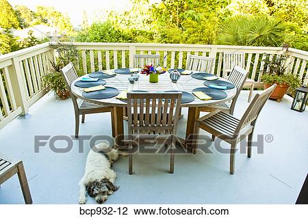 Stock Image - outdoor table set for dinner. Fotosearch