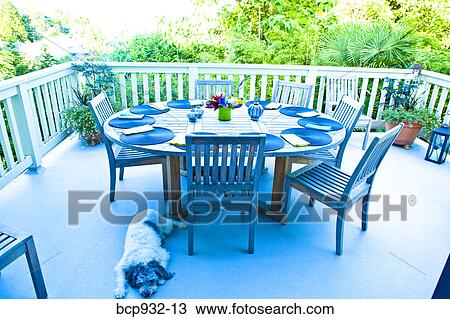 Stock Image - outdoor table set for dinner. Fotosearch