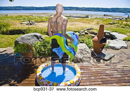 tattoed man in wading pool near beach View Large Photo Image Stock Photo - tattoed man in wading pool near beach. Fotosearch