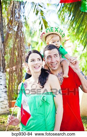 Picture - tattoed mom and dad with baby. Fotosearch