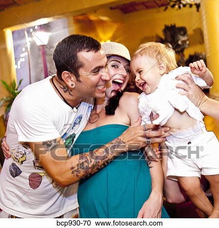 Stock Image - tattoed mom and dad with baby. Fotosearch