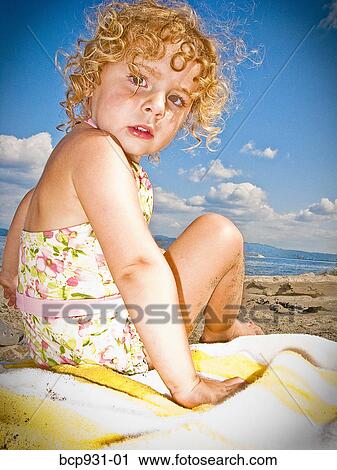 Stock Image - toddler girl on beach. Fotosearch