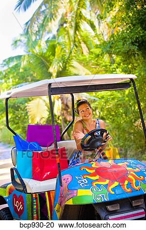 Stock Image - Woman shopping with golf cart in mexico. Fotosearch