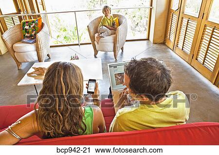 adults using electronics while child watches View Large Photo Image Stock Image - adults using electronics while child watches. Fotosearch