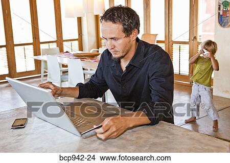 child taking photo of man with laptop View Large Photo Image Picture - child taking photo of man with laptop. Fotosearch