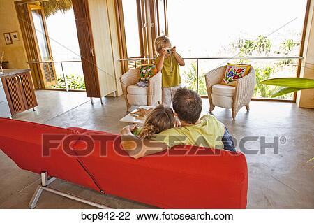child taking photo of parents on sofa View Large Photo Image Stock Image - child taking photo of parents on sofa. Fotosearch