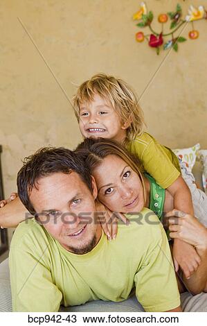 family cuddling on bed View Large Photo Image Stock Image - family cuddling on bed. Fotosearch