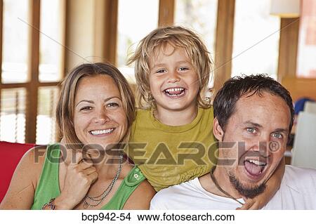 family cuddling on sofa View Large Photo Image Picture - family cuddling on sofa. Fotosearch