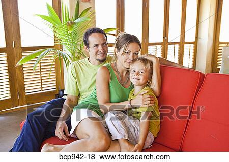 family cuddling on sofa View Large Photo Image Stock Photo - family cuddling on sofa. Fotosearch