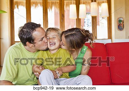 family cuddling on sofa View Large Photo Image Stock Photo - family cuddling on sofa. Fotosearch