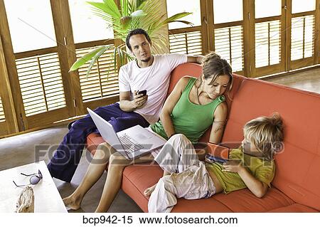 family on sofa with laptop View Large Photo Image Stock Photography - family on sofa with laptop. Fotosearch