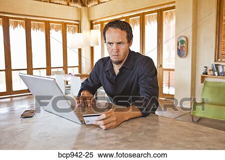man working on laptop at home View Large Photo Image Stock Photography - man working on laptop at home. Fotosearch