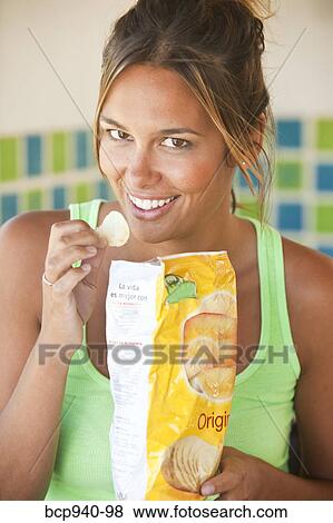 woman eating potato chips View Large Photo Image Stock Photo - woman eating potato chips. Fotosearch