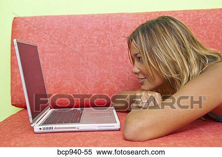 woman lying on couch with laptop View Large Photo Image Stock Photography - woman lying on couch with laptop. Fotosearch