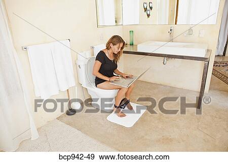woman on laptop in bathroom View Large Photo Image Stock Photo - woman on laptop in bathroom. Fotosearch