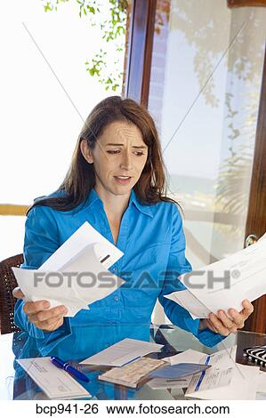 woman paying bills at dining room table View Large Photo Image Stock Photograph - woman paying bills at dining room table. Fotosearch