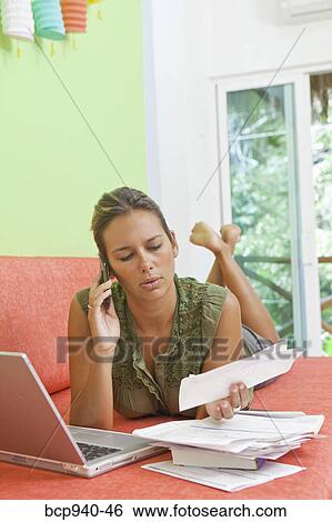 woman paying bills on couch View Large Photo Image Stock Photograph - woman paying bills on couch. Fotosearch