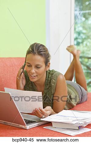 woman paying bills on couch View Large Photo Image Stock Photography - woman paying bills on couch. Fotosearch