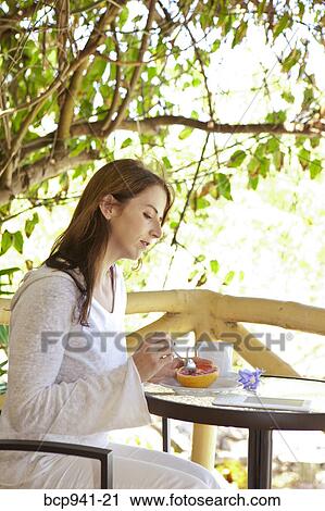 woman reading e-book on balcony View Large Photo Image Stock Image - woman reading e-book on balcony. Fotosearch