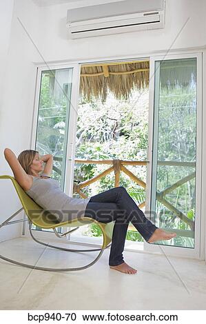 Stock Image - woman relaxing in chair. Fotosearch