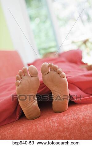 woman sleeping with feet out from covers View Large Photo Image Stock Photo - woman sleeping with feet out from covers. Fotosearch