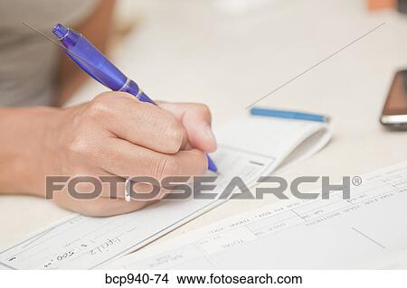 woman's hand writing checks View Large Photo Image Picture - woman's hand writing checks. Fotosearch