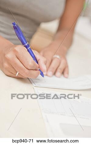 woman's hand writing checks View Large Photo Image Stock Image - woman's hand writing checks. Fotosearch