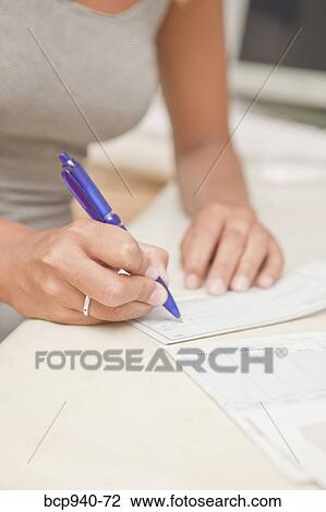 woman's hand writing checks View Large Photo Image Stock Image - woman's hand writing checks. Fotosearch
