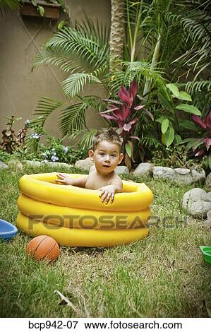 young boy playing in paddling pool View Large Photo Image Stock Photo - young boy playing in paddling pool. Fotosearch