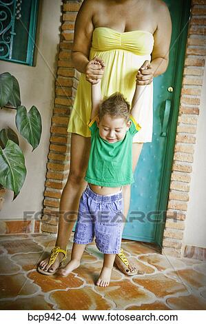 Picture - young mexican boy and woman in doorway. Fotosearch