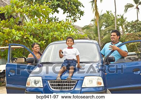 young mexican family with car View Large Photo Image Stock Photo - young mexican family with car. Fotosearch
