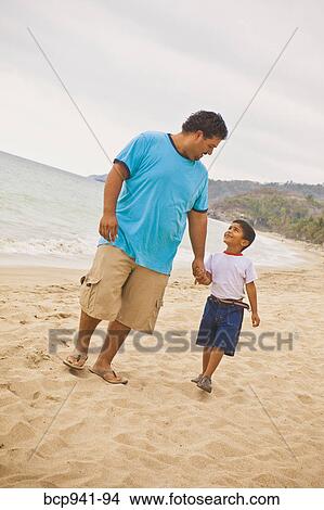 young mexican father and son on beach View Large Photo Image Picture - young mexican father and son on beach. Fotosearch