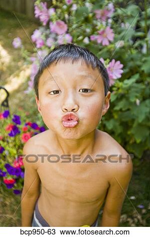 asian boy with puckered lips outdoors View Large Photo Image Stock Image - asian boy with puckered lips outdoors. Fotosearch