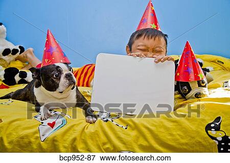 boy and dog on bed with blank sign View Large Photo Image Stock Photo - boy and dog on bed with blank sign. Fotosearch