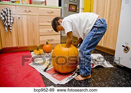 boy carving jack o'lantern View Large Photo Image Stock Photo - boy carving jack o'lantern. Fotosearch