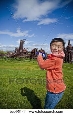 Stock Image - boy flying kite at gasworks park. Fotosearch