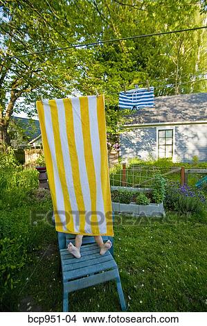 boy on garden chair under beach towel View Large Photo Image Picture - boy on garden chair under beach towel. Fotosearch