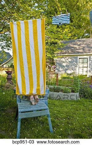 boy on garden chair under beach towel View Large Photo Image Stock Image - boy on garden chair under beach towel. Fotosearch