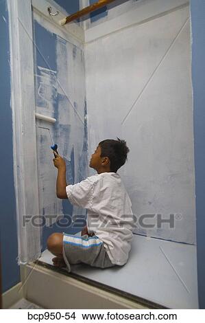 Picture - boy painting wall in closet. Fotosearch