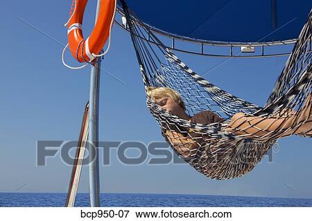 boy resting in hammock on yacht View Large Photo Image Stock Photo - boy resting in hammock on yacht. Fotosearch