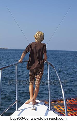 boy standing on bow of yacht View Large Photo Image Stock Photograph - boy standing on bow of yacht. Fotosearch