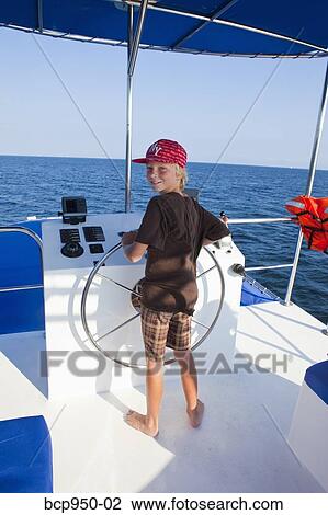 boy steering yacht View Large Photo Image Stock Image - boy steering yacht. Fotosearch