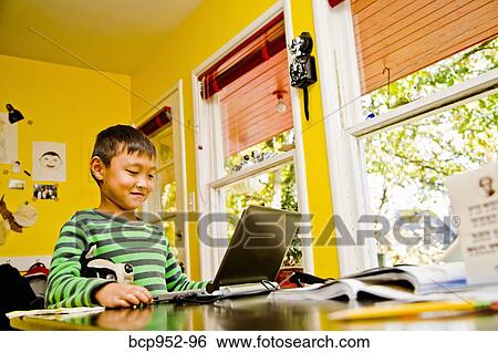 boy with laptop at kitchen table View Large Photo Image Stock Photograph - boy with laptop at kitchen table. Fotosearch