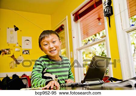 boy with laptop at kitchen table View Large Photo Image Stock Photography - boy with laptop at kitchen table. Fotosearch