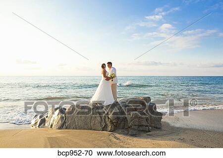 bridal couple hugging on beach View Large Photo Image Stock Image - bridal couple hugging on beach. Fotosearch